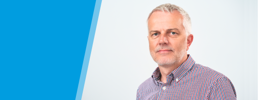 Headshot of Ian to the right of the WJEC CBAC logo